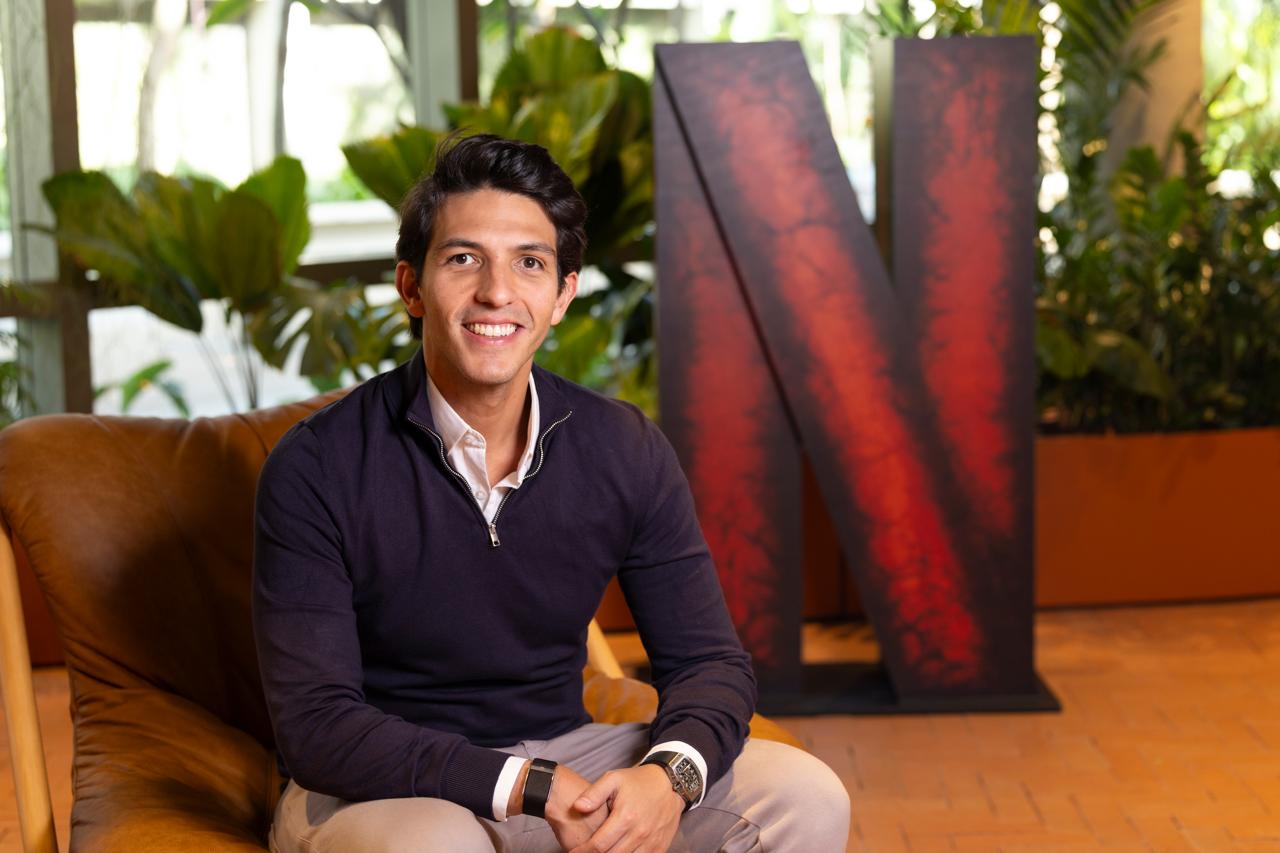 Walter Motta Jr. seated in a leather armchair at Netflix
